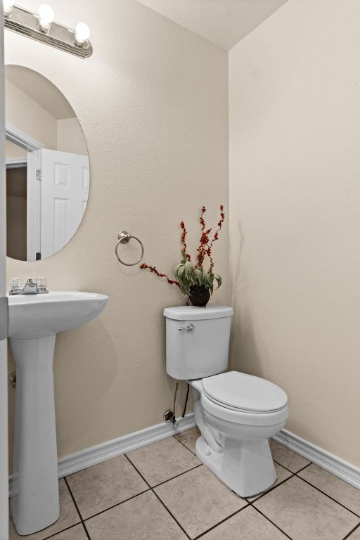 10 Saul St, Lampasas, TX 76550 - bathroom featuring toilet, baseboards, and tile patterned floors