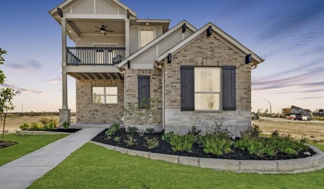 8169 Daisy Cutter Xing, Georgetown, TX 78626 - view of front facade with a balcony, a ceiling fan, a lawn, and brick siding