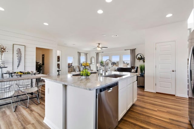 8169 Daisy Cutter Xing, Georgetown, TX 78626 - kitchen featuring appliances with stainless steel finishes, a sink, light wood finished floors, light stone countertops, and white cabinets