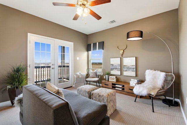 8169 Daisy Cutter Xing, Georgetown, TX 78626 - living room featuring carpet floors, baseboards, a ceiling fan, and french doors