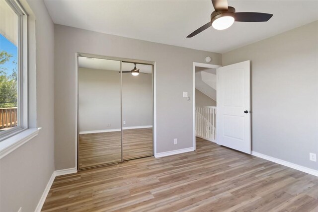 1145 Lago Vista St, San Marcos, TX 78666 - unfurnished bedroom featuring light wood-type flooring, a closet, and a ceiling fan