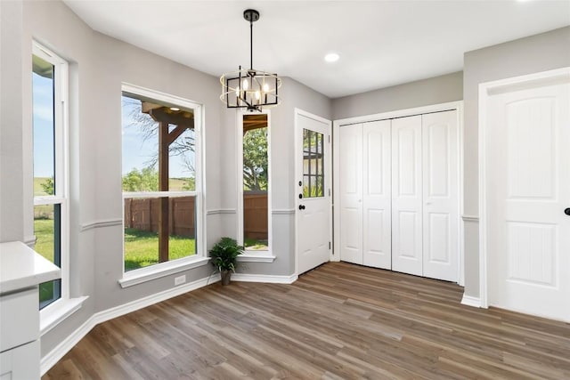 1145 Lago Vista St, San Marcos, TX 78666 - unfurnished dining area featuring wood finished floors, a chandelier, baseboards, and recessed lighting