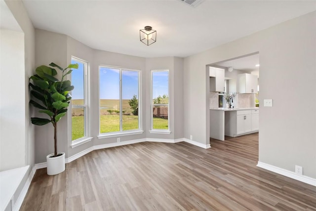 1145 Lago Vista St, San Marcos, TX 78666 - unfurnished dining area featuring wood finished floors and baseboards