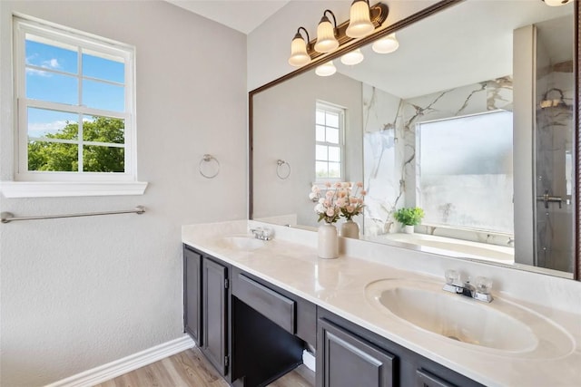 1145 Lago Vista St, San Marcos, TX 78666 - bathroom featuring double vanity, a marble finish shower, a tub, and wood finished floors