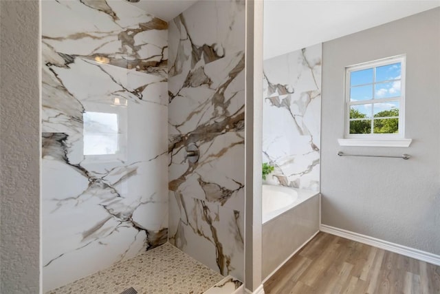 1145 Lago Vista St, San Marcos, TX 78666 - full bathroom with a bath, wood finished floors, a marble finish shower, and baseboards