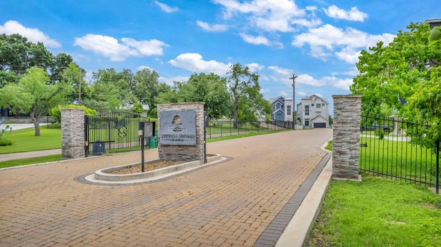 127 Cypress Shores Ln, Kingsland, TX 78639 - view of decorative road featuring a gated entry and curbs