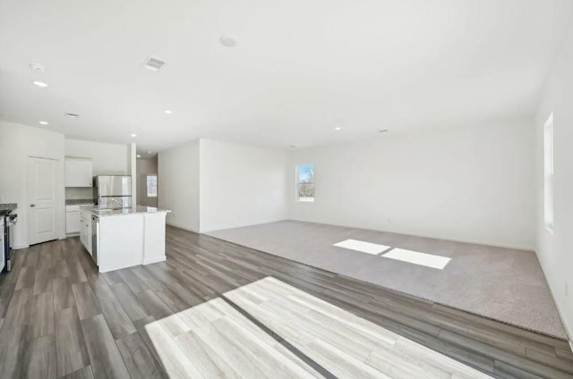 1504 Morris Loop, San Marcos, TX 78666 - unfurnished living room with wood finished floors and recessed lighting