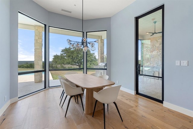 7816 Lynchburg Dr, Austin, TX 78738 - dining space featuring light wood-style flooring, a chandelier, and baseboards
