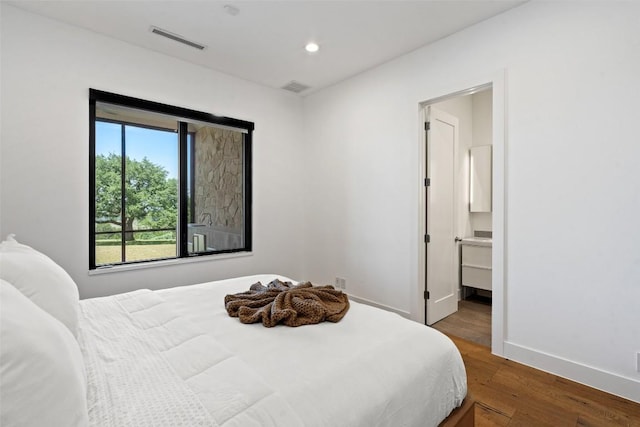 7816 Lynchburg Dr, Austin, TX 78738 - bedroom with wood finished floors, recessed lighting, baseboards, and ensuite bathroom