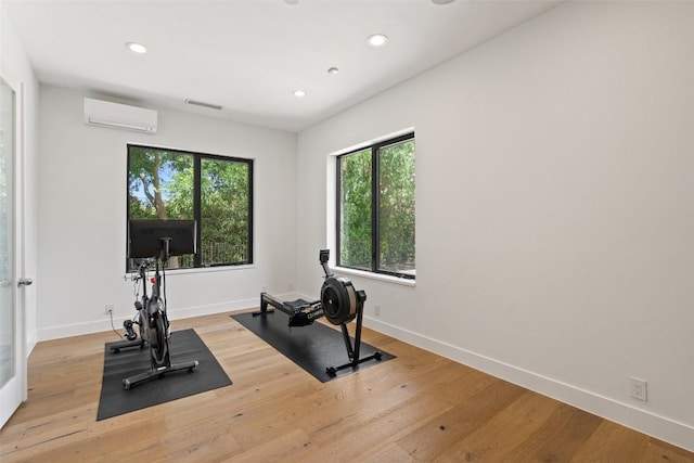 7816 Lynchburg Dr, Austin, TX 78738 - workout room featuring a wall mounted air conditioner, recessed lighting, light wood-type flooring, and baseboards