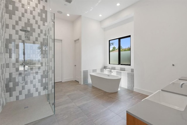 7816 Lynchburg Dr, Austin, TX 78738 - bathroom featuring a shower stall, a freestanding tub, vanity, and recessed lighting