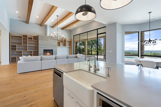 7816 Lynchburg Dr, Austin, TX 78738 - kitchen with a chandelier, stainless steel dishwasher, beam ceiling, light wood-style floors, and a sink