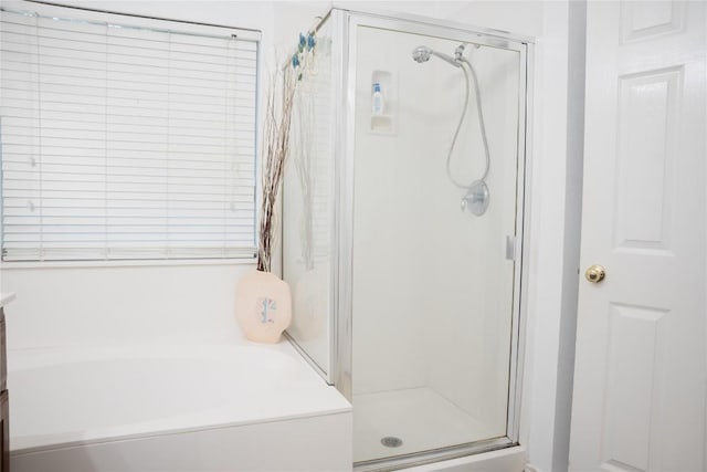 9305 Pioneer Forest Dr, Austin, TX 78744 - full bathroom featuring a stall shower and a garden tub