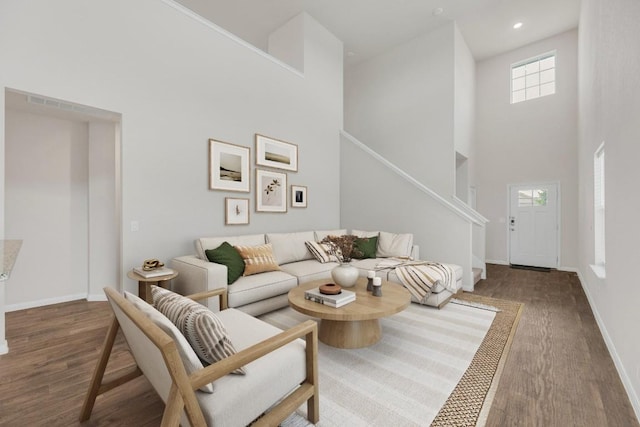 2900 Tweedy Trl, Pflugerville, TX 78660 - living area featuring a towering ceiling, wood finished floors, stairway, and recessed lighting
