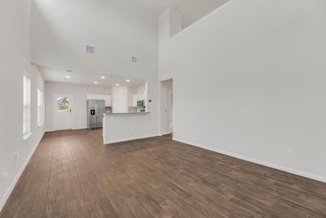 2900 Tweedy Trl, Pflugerville, TX 78660 - unfurnished living room with dark wood-type flooring and baseboards