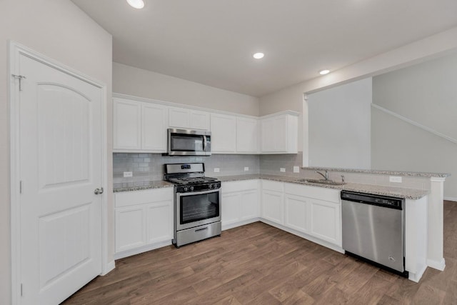 2900 Tweedy Trl, Pflugerville, TX 78660 - kitchen with stainless steel appliances, backsplash, light stone countertops, and recessed lighting