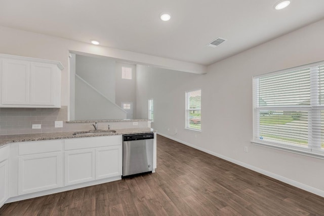 2900 Tweedy Trl, Pflugerville, TX 78660 - kitchen featuring dishwasher, white cabinets, dark wood-style floors, light stone countertops, and a peninsula