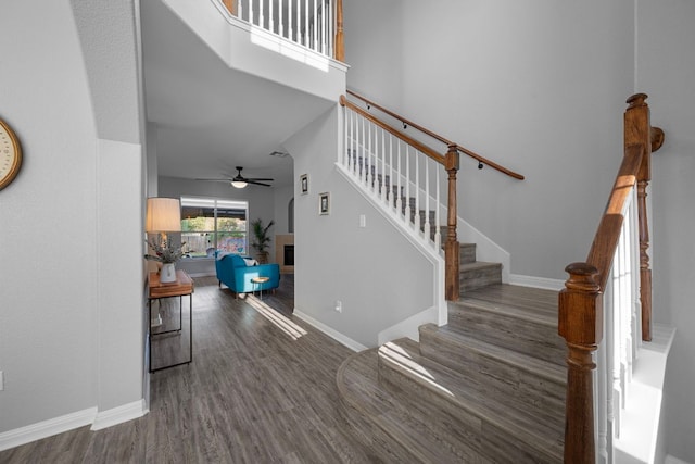 2208 Barnett Dr, Cedar Park, TX 78613 - foyer featuring wood finished floors, a fireplace, a ceiling fan, stairway, and baseboards