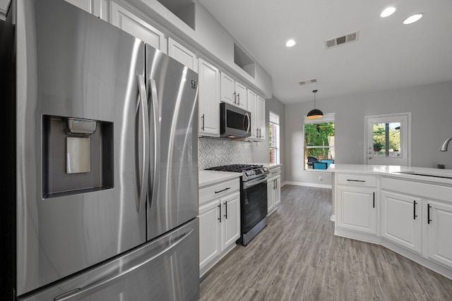 2208 Barnett Dr, Cedar Park, TX 78613 - kitchen with appliances with stainless steel finishes, a sink, recessed lighting, white cabinetry, and light countertops