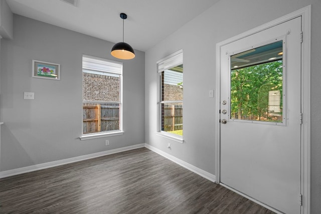 2208 Barnett Dr, Cedar Park, TX 78613 - unfurnished dining area featuring dark wood-type flooring and baseboards