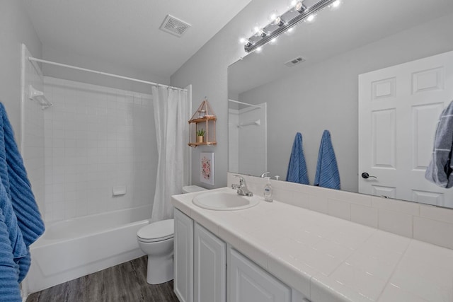 2208 Barnett Dr, Cedar Park, TX 78613 - bathroom with shower / bath combination with curtain, vanity, toilet, and wood finished floors