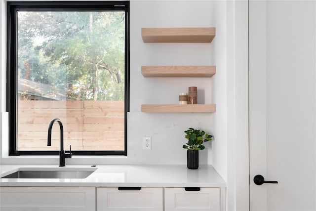 3001 E 51st St Unit 4, Austin, TX 78723 - kitchen with a sink, open shelves, white cabinetry, and light countertops