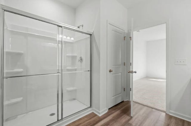 129 Bridgeview Dr, Hutto, TX 78634 - full bathroom with a shower stall, wood finished floors, and baseboards