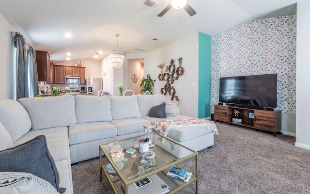 1678 Woodlands Dr, Kyle, TX 78640 - carpeted living room featuring vaulted ceiling, ceiling fan, and a chandelier
