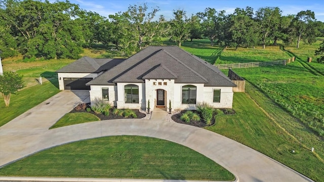 view of front of home featuring concrete driveway and a front yard
