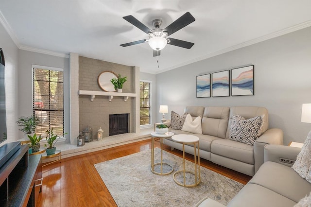 4159 Steck Ave Unit 162, Austin, TX 78759 - living room with wood finished floors, a brick fireplace, a ceiling fan, and ornamental molding