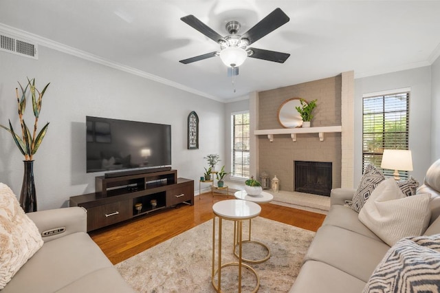4159 Steck Ave Unit 162, Austin, TX 78759 - living area featuring wood finished floors, ornamental molding, ceiling fan, a brick fireplace, and baseboards