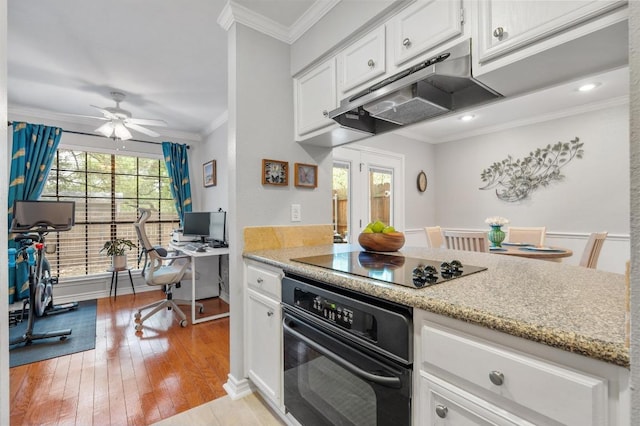 4159 Steck Ave Unit 162, Austin, TX 78759 - kitchen featuring black appliances, under cabinet range hood, crown molding, white cabinetry, and light wood-type flooring