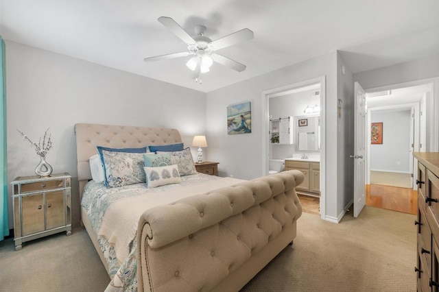 4159 Steck Ave Unit 162, Austin, TX 78759 - bedroom featuring light carpet, a sink, ensuite bathroom, ceiling fan, and baseboards