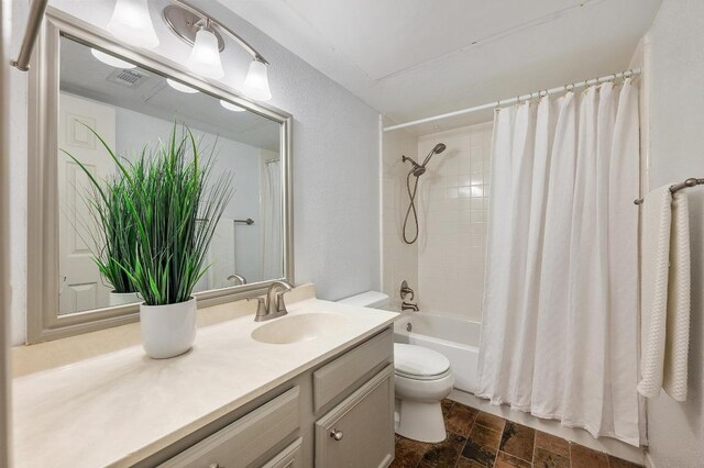 4159 Steck Ave Unit 162, Austin, TX 78759 - bathroom with toilet, vanity, shower / bath combination with curtain, and stone finish floors