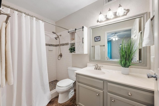 4159 Steck Ave Unit 162, Austin, TX 78759 - full bath with toilet, vanity, a tile shower, a ceiling fan, and a textured wall
