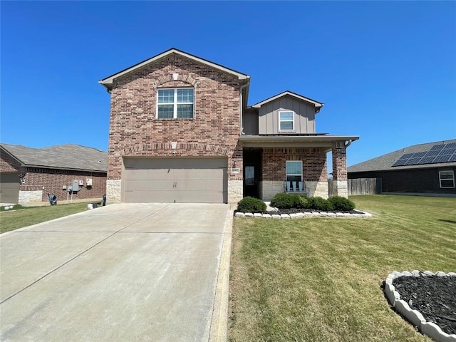 19900 Hubert R Humphrey Rd, Manor, TX 78653 - traditional home with board and batten siding, a garage, driveway, a front yard, and brick siding