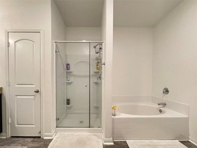 19900 Hubert R Humphrey Rd, Manor, TX 78653 - full bathroom featuring a stall shower, a bath, wood finished floors, and baseboards