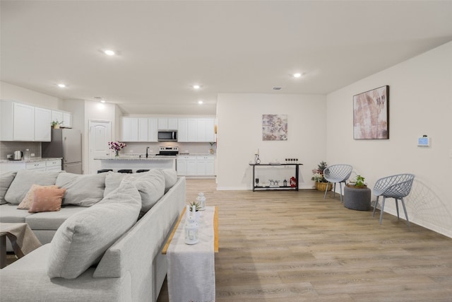 109 Egret Dr, Bastrop, TX 78602 - living area with recessed lighting, light wood-style floors, and baseboards