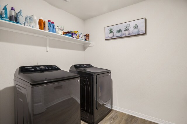 109 Egret Dr, Bastrop, TX 78602 - laundry area with separate washer and dryer, wood finished floors, and baseboards