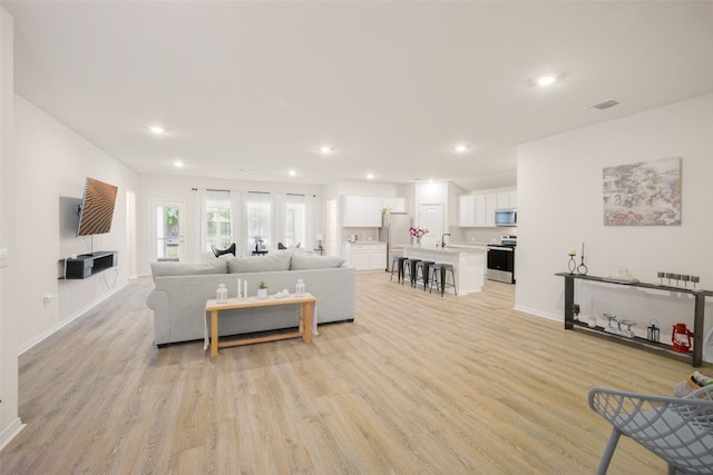 109 Egret Dr, Bastrop, TX 78602 - living room with light wood-type flooring, recessed lighting, and baseboards