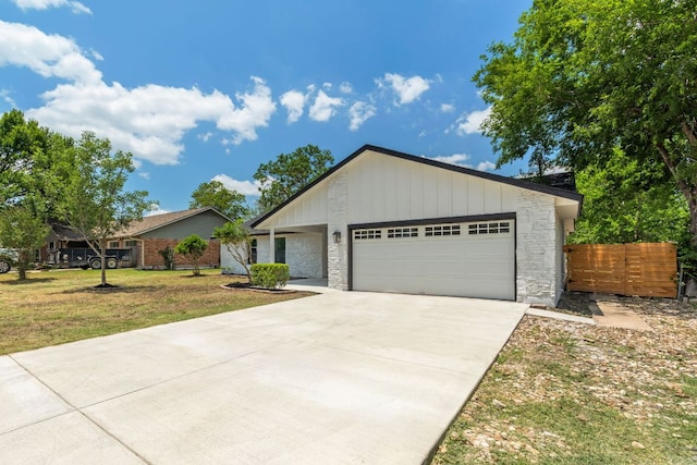14806 Parco Path, Pflugerville, TX 78660 - single story home featuring an attached garage, concrete driveway, and stone siding