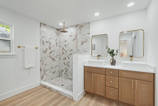 14806 Parco Path, Pflugerville, TX 78660 - bathroom featuring wood finished floors, a marble finish shower, double vanity, baseboards, and recessed lighting