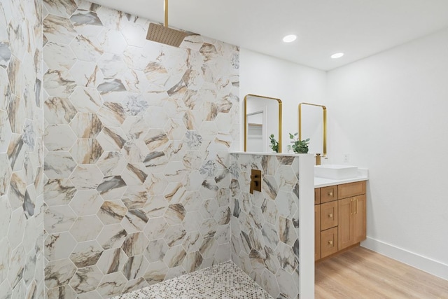 14806 Parco Path, Pflugerville, TX 78660 - bathroom with vanity, wood finished floors, a walk in shower, baseboards, and recessed lighting