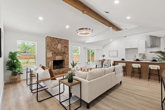 14806 Parco Path, Pflugerville, TX 78660 - living room featuring plenty of natural light, light wood-style flooring, a fireplace, recessed lighting, and a chandelier