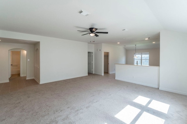 19642 Summerlin Dr, Katy, TX 77449 - unfurnished living room featuring carpet floors, arched walkways, a ceiling fan, recessed lighting, and baseboards
