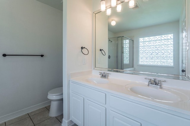 19642 Summerlin Dr, Katy, TX 77449 - bathroom featuring toilet, tile patterned floors, an enclosed shower, double vanity, and baseboards