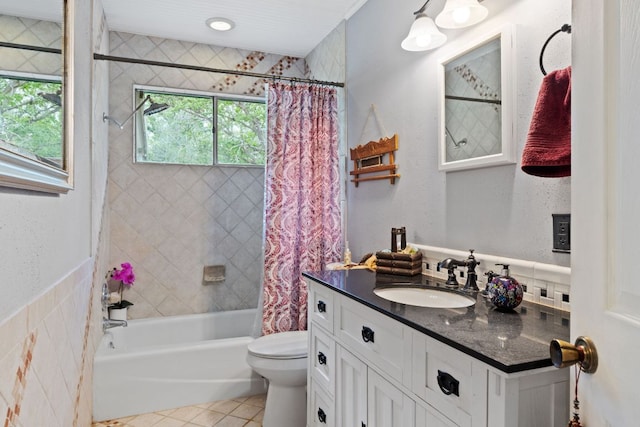 1603 Purple Sage, Horseshoe Bay, TX 78657 - full bathroom featuring vanity, shower / tub combo, tile patterned flooring, and toilet