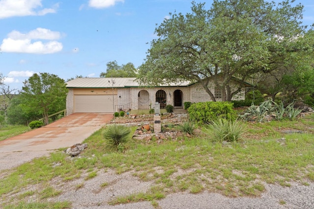 1603 Purple Sage, Horseshoe Bay, TX 78657 - view of front of home featuring an attached garage, concrete driveway, and brick siding