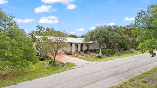 1603 Purple Sage, Horseshoe Bay, TX 78657 - view of front facade with driveway and metal roof
