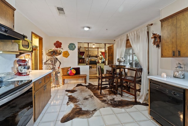 1603 Purple Sage, Horseshoe Bay, TX 78657 - kitchen with black appliances, brown cabinets, light countertops, and under cabinet range hood